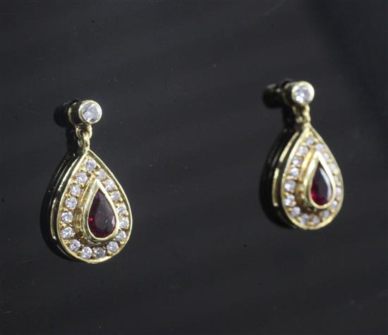 A pair of 18ct gold ruby and diamond pear shaped drop earrings, 15mm.